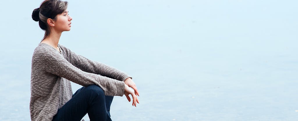 Young woman relaxing outdoors and wondering how long a credit card refund takes.