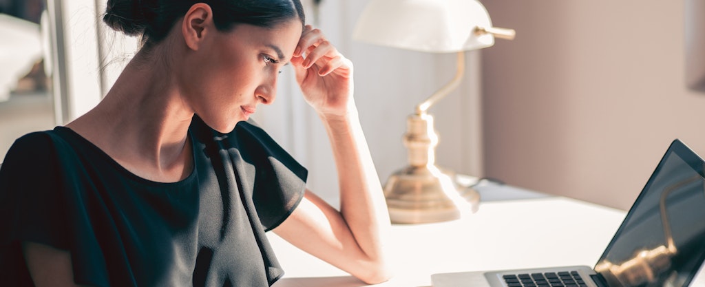 woman sitting at desk looking at laptop and wondering how long public records are available