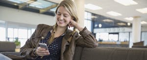 Woman with backpack and cell phone in airport