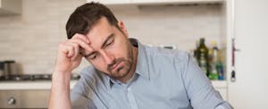 Frustrated man calculating bills