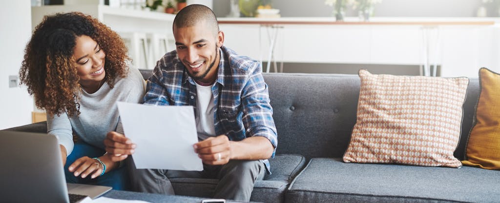 Young couple going through their paperwork together at home