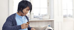 Young man using credit card and laptop
