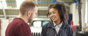 extended-car-warranty Mechanic explaining the cost of a car repair to car owner