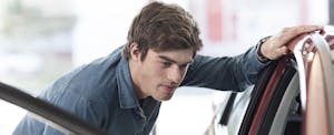 negative-equity-car-trade-in Man looking at the inside of a car