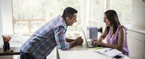 lease-buyout-what-to-know Man and a woman working together at their kitchen counter
