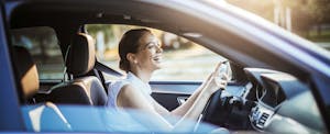 what-is-a-manufacturer-warranty_664838958 Businesswoman driving a car