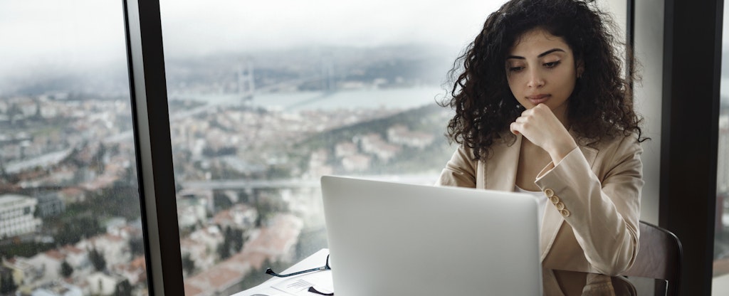 Businesswoman working on laptop in her hotel
