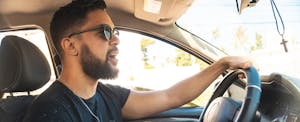 Man driving a car and singing