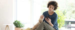 Woman with laptop looking up getting a loan with no bank account