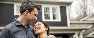 Happy couple in front of their new South Carolina home