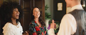 Two women in hotel, learning about IHG rewards points