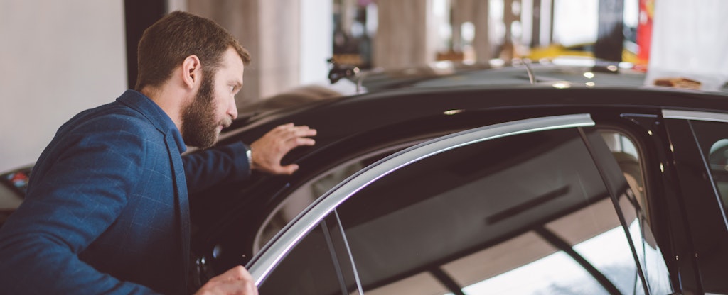Man looking at a used car from Enterprise