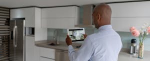 Man taking pictures of the kitchen in his rental investment property